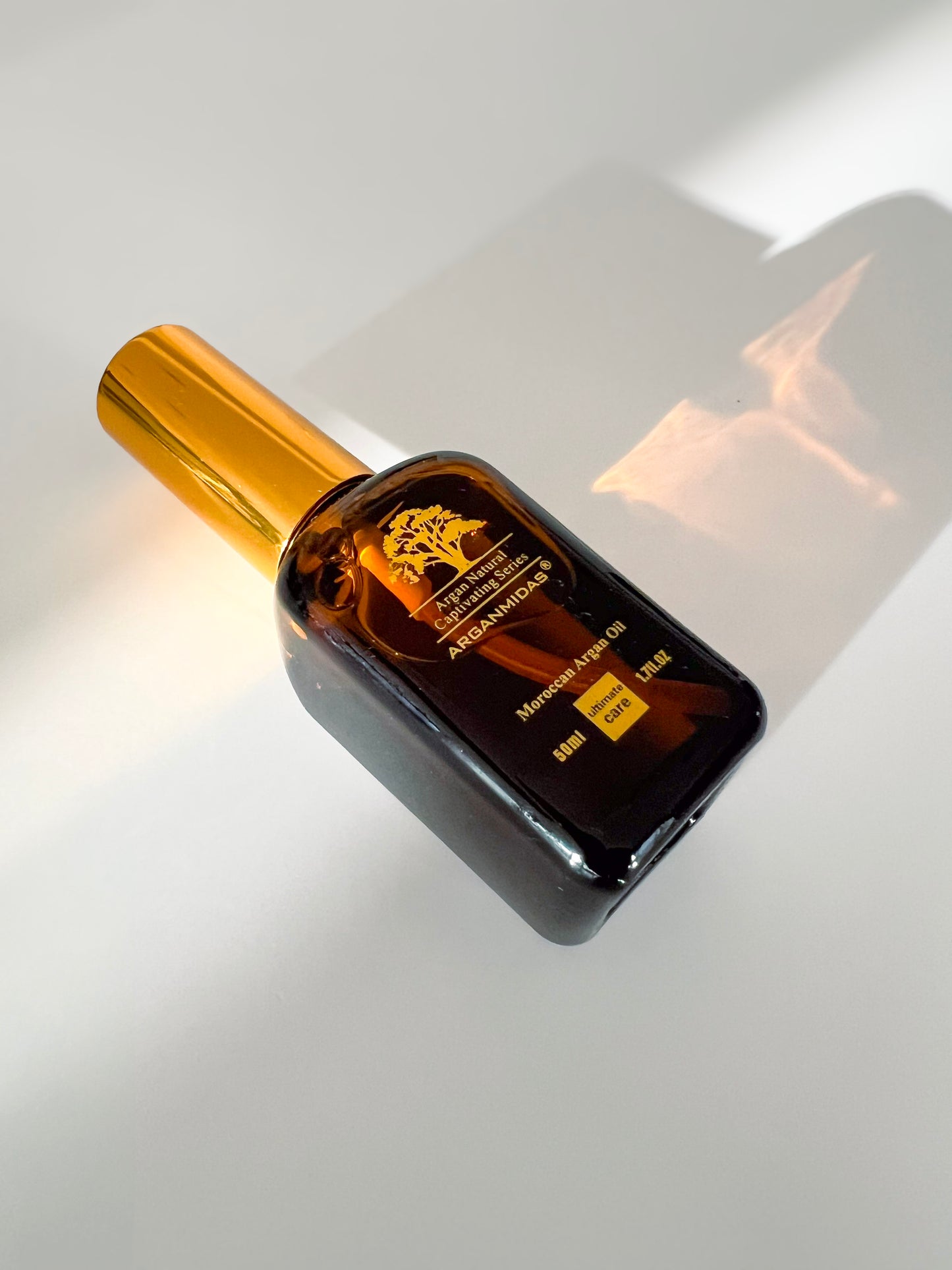 Black and gold bottle on a reflective surface